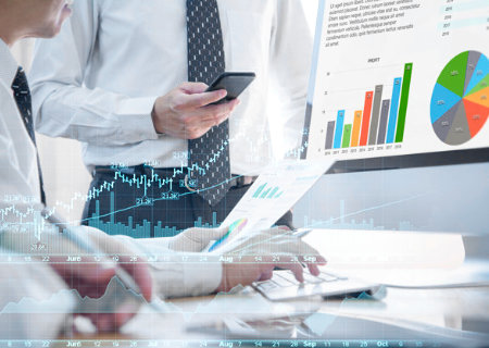 Two colleagues discussing chart and graph data.