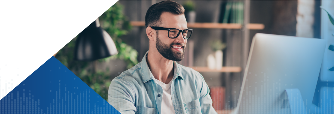 Smiling man at his desk.